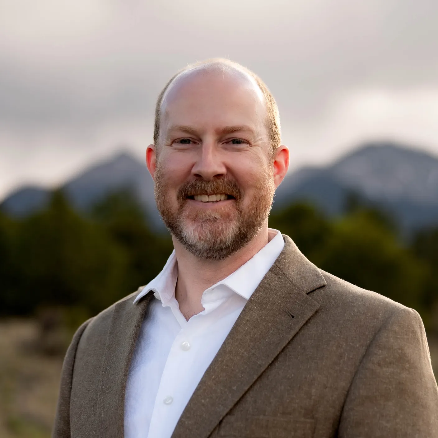Jarrod Carlson in the Colorado foothills, mountains behind him.